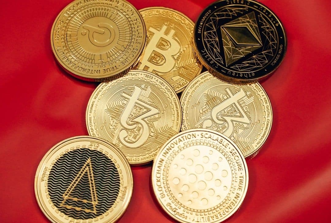 a pile of bitcoins sitting on top of a red cloth