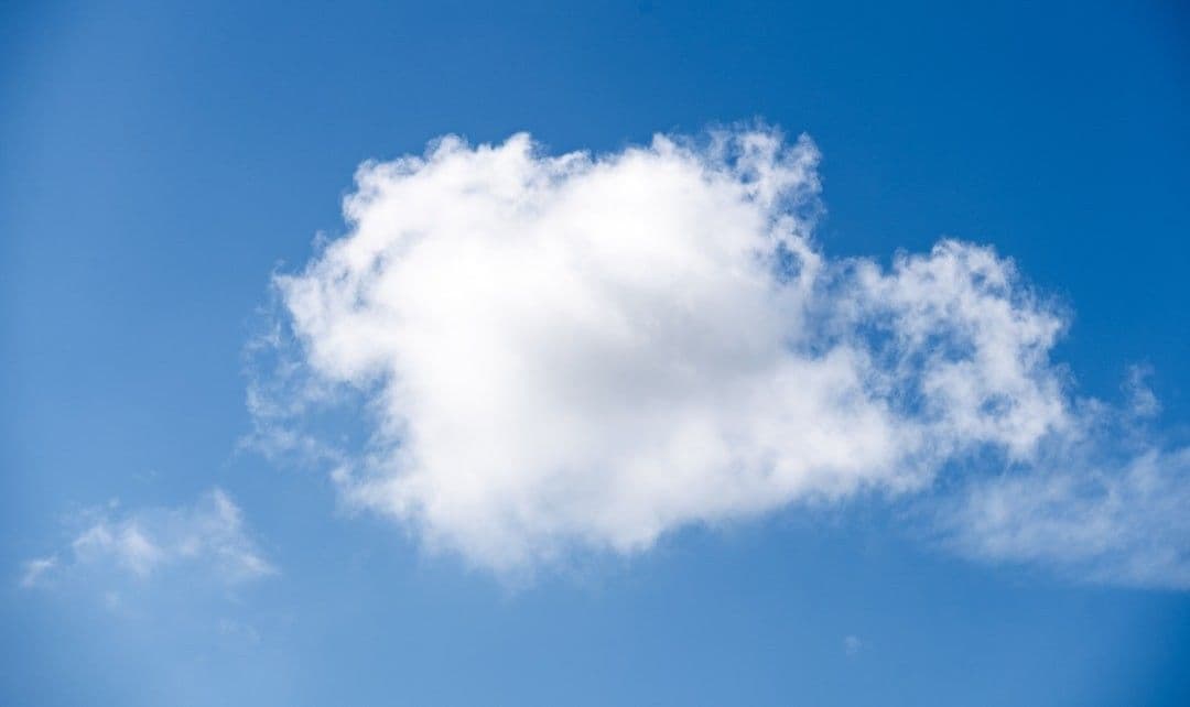 a white cloud in a blue sky