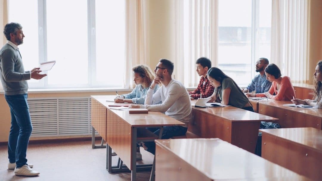 Teacher instructing students in a classroom lecture.