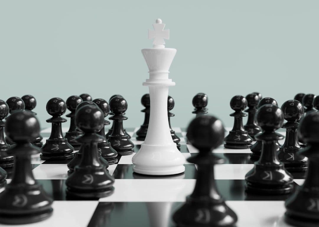 White king stands surrounded by black pawns.