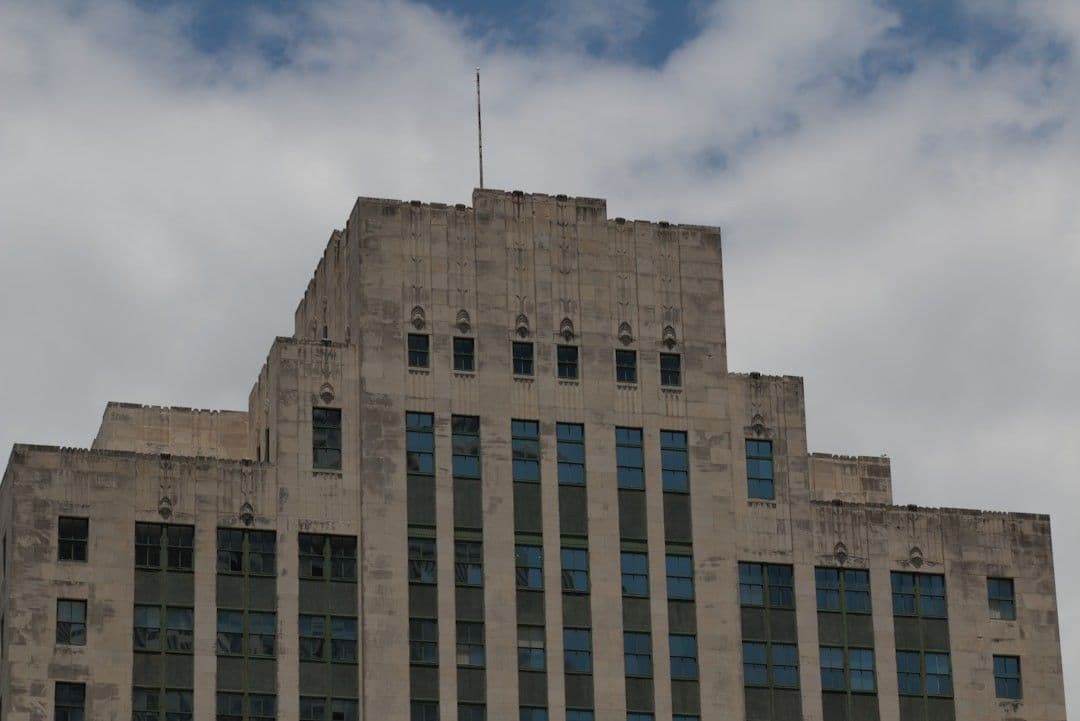Art deco building with geometric patterns under cloudy sky