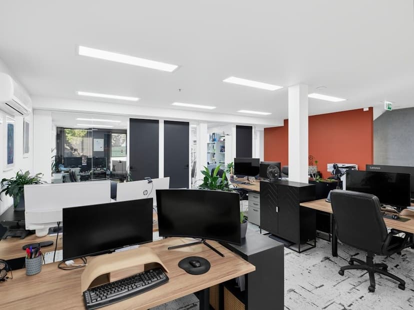 Modern office space with desks and computers.