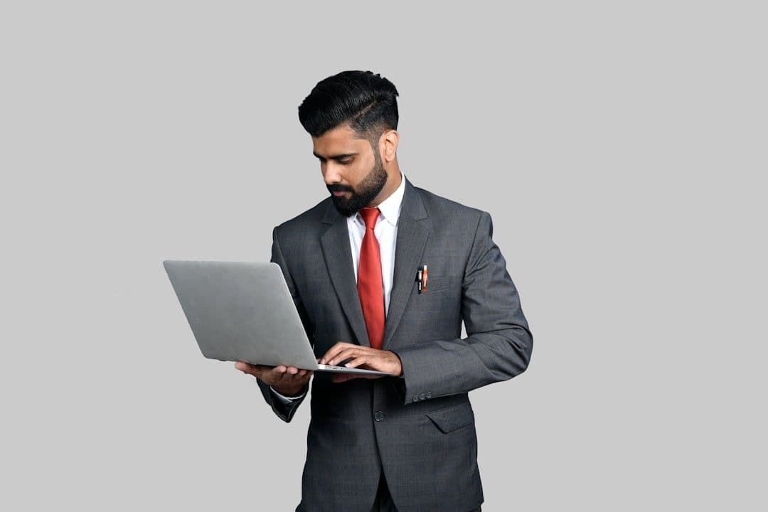 a man in a suit holding a tablet