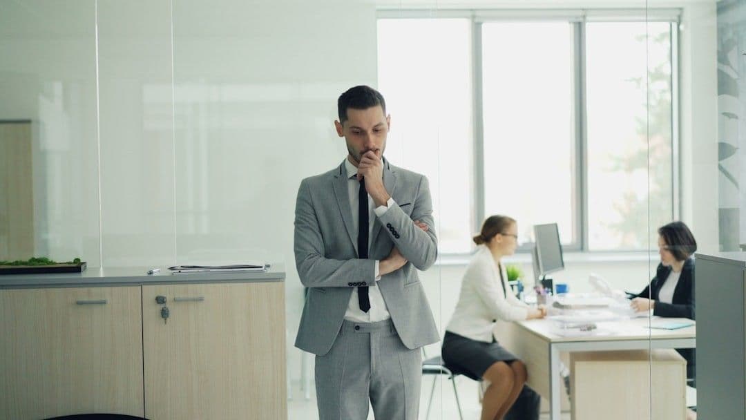 Man in suit thinking in modern office environment