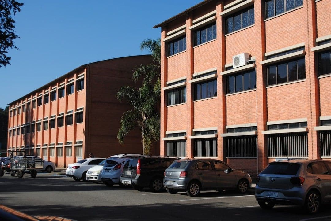 A parking lot with cars parked in front of a building