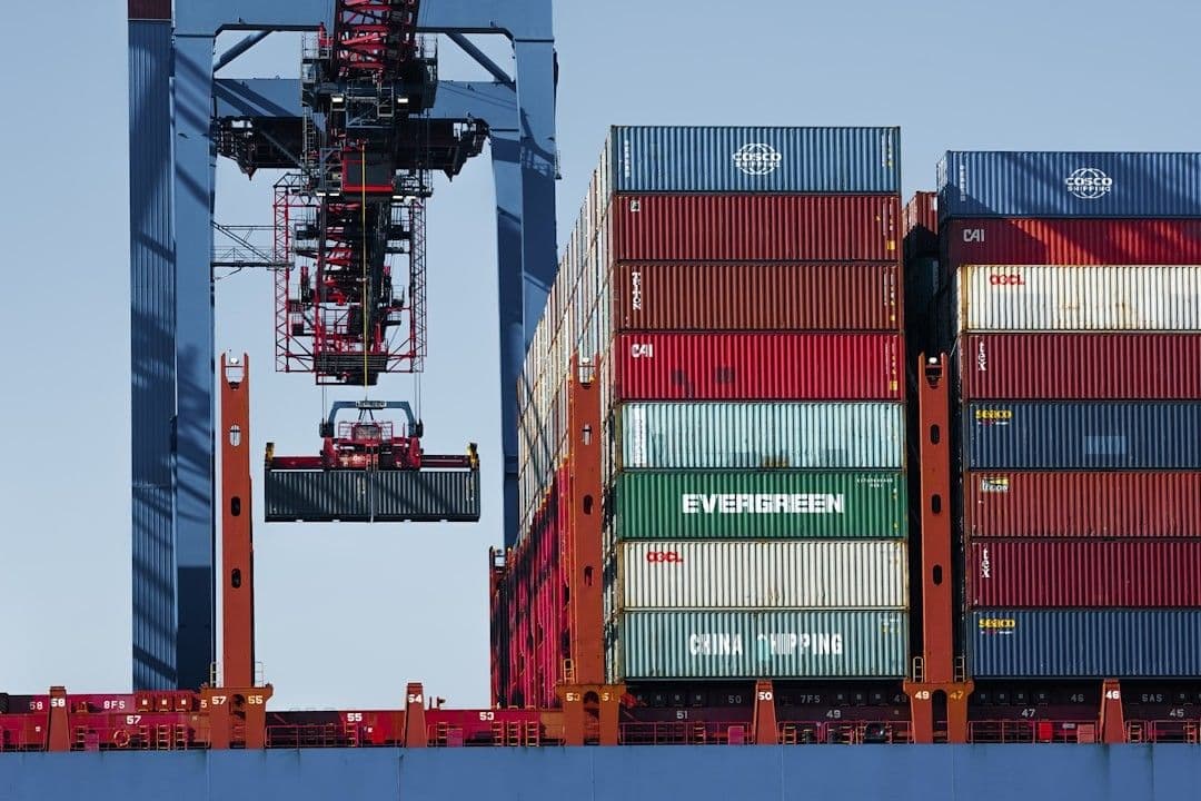 Crane loading shipping containers onto a cargo ship.