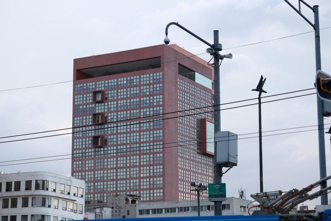 a tall red building sitting next to a traffic light