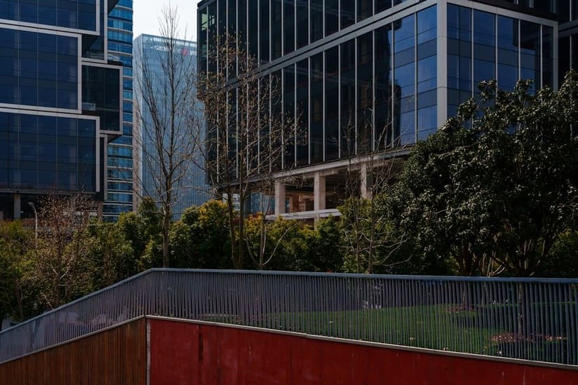 Modern buildings with trees and a red wall